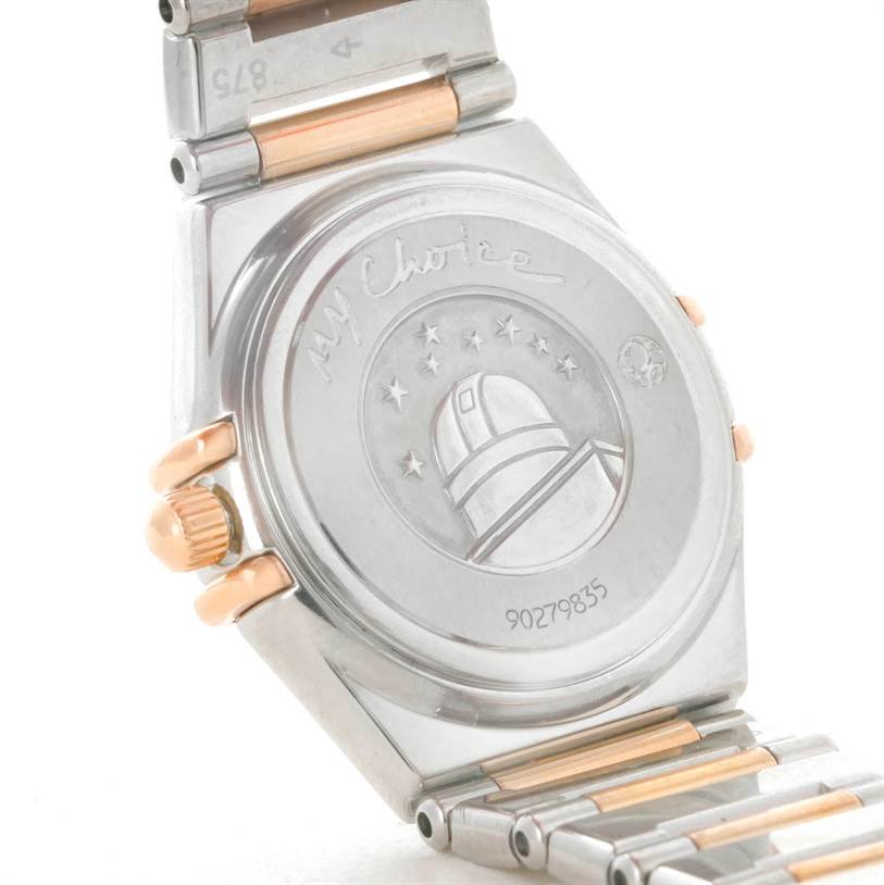 The image shows the back side of the Omega 1368.71.00 Women
s Steel and Gold (two tone) Mother of Pearl Dial 1368.71.00 Women
s Steel and Gold (two tone) Mother of Pearl Dial Constellation My Choice Mini Diamond Watch 1368.71.00 with a glimpse of the bracelet.