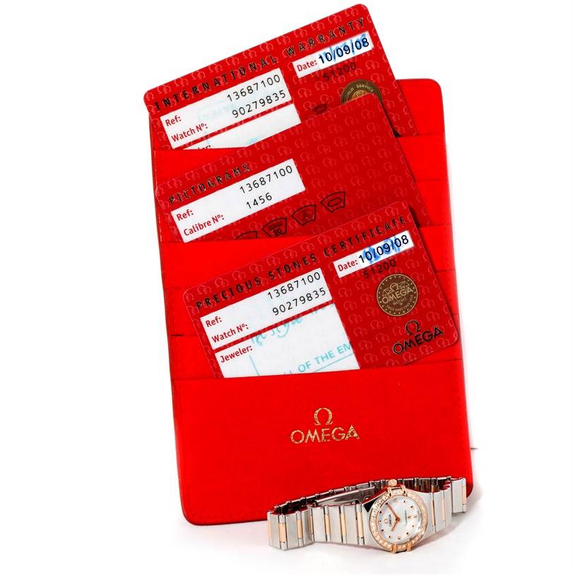 The image features the Omega 1368.71.00 Women
s Steel and Gold (two tone) Mother of Pearl Dial 1368.71.00 Women
s Steel and Gold (two tone) Mother of Pearl Dial Constellation My Choice Mini Diamond Watch 1368.71.00, box papers, and red certification cards.