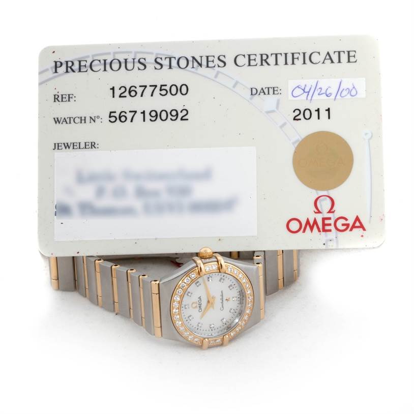 The image shows the Omega 1267.75.00 Women
s Steel and Gold (two tone) Mother of Pearl Dial 1267.75.00 Women
s Steel and Gold (two tone) Mother of Pearl Dial Constellation My Choice Steel Gold Diamond Watch 1267.75.00 with its certificate.