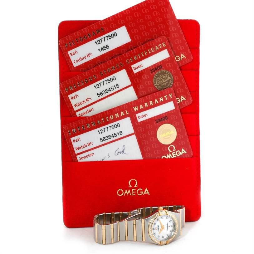 The image shows the Omega 1277.75.00 Women
s Steel and Gold (two tone) Mother of Pearl Dial 1277.75.00 Women
s Steel and Gold (two tone) Mother of Pearl Dial Constellation My Choice Steel Gold Diamond Watch 1277.75.00 with warranty cards and certificates.