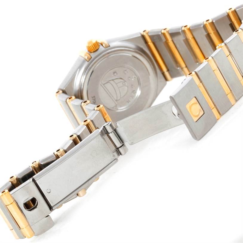 The image shows the back of the Omega 1267.70.00 Women
s Steel and Gold (two tone) Mother of Pearl Dial 1267.70.00 Women
s Steel and Gold (two tone) Mother of Pearl Dial Constellation My Choice Mini Steel Gold Diamond Watch 1267.70.00, highlighting the clasp and bracelet.