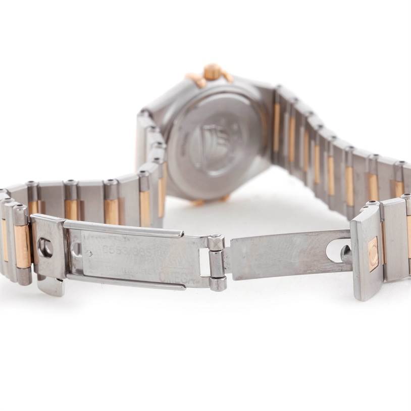 The image shows the back case and partially open bracelet of the Omega 1360.75.00 Women
s Steel and Gold (two tone) Mother of Pearl Dial 1360.75.00 Women
s Steel and Gold (two tone) Mother of Pearl Dial Constellation My Choice Mini Diamond Watch 1360.75.00.