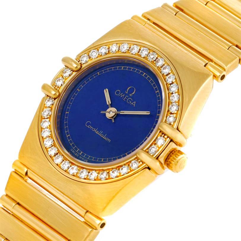 The Omega Women
s Blue Dial Women
s Blue Dial Constellation 18K Yellow Gold Diamond Lapis Dial Watch is shown from a three-quarter angle, displaying the face, bezel, and part of the bracelet.