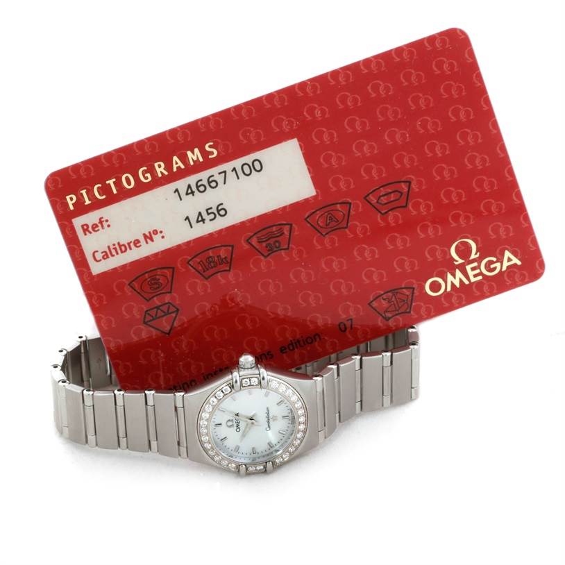 This image shows the Omega 1466.71.00 Women
s Stainless Steel Mother of Pearl Dial 1466.71.00 Women
s Stainless Steel Mother of Pearl Dial Constellation 95 My Choice Ladies Mini Watch 1466.71.00 along with its red warranty card.