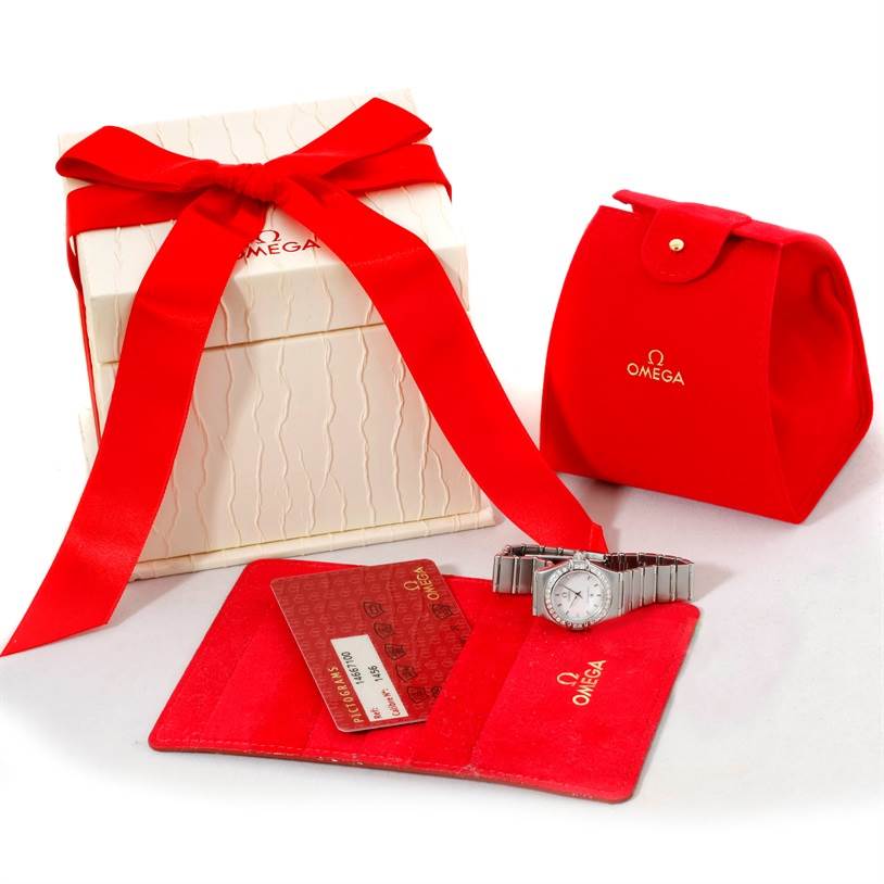The image shows an Omega 1466.71.00 Women
s Stainless Steel Mother of Pearl Dial 1466.71.00 Women
s Stainless Steel Mother of Pearl Dial Constellation 95 My Choice Ladies Mini Watch 1466.71.00 with its packaging, red pouch, cards, and gift box.