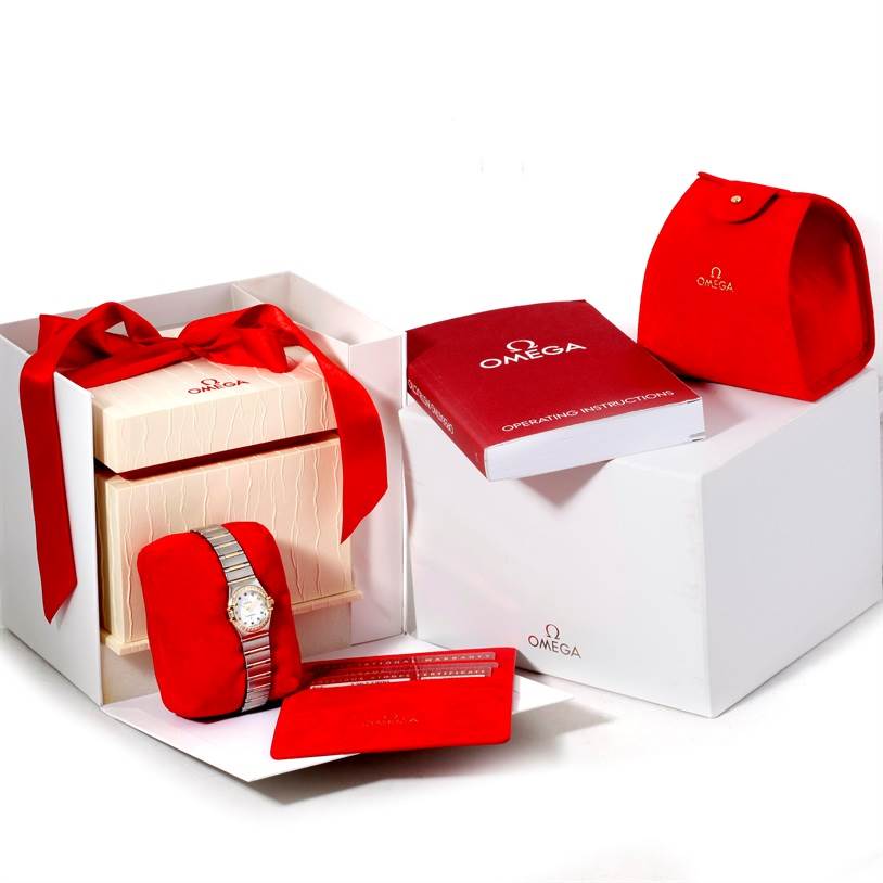 The Omega 1367.79.00 Women
s Steel and Gold (two tone) Mother of Pearl Dial 1367.79.00 Women
s Steel and Gold (two tone) Mother of Pearl Dial Constellation Iris Steel Yellow Gold Multi Stone Watch 1367.79.00 is shown with its box, manual, and accessories from a top angle.