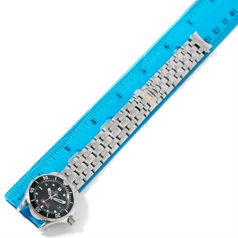 The image shows an Omega 212.30.28.61.01.001 Women
s Stainless Steel Black Dial 212.30.28.61.01.001 Women
s Stainless Steel Black Dial Seamaster Professional 300 M Ladies Watch 212.30.28.61.01.001 laid out next to a blue ruler.