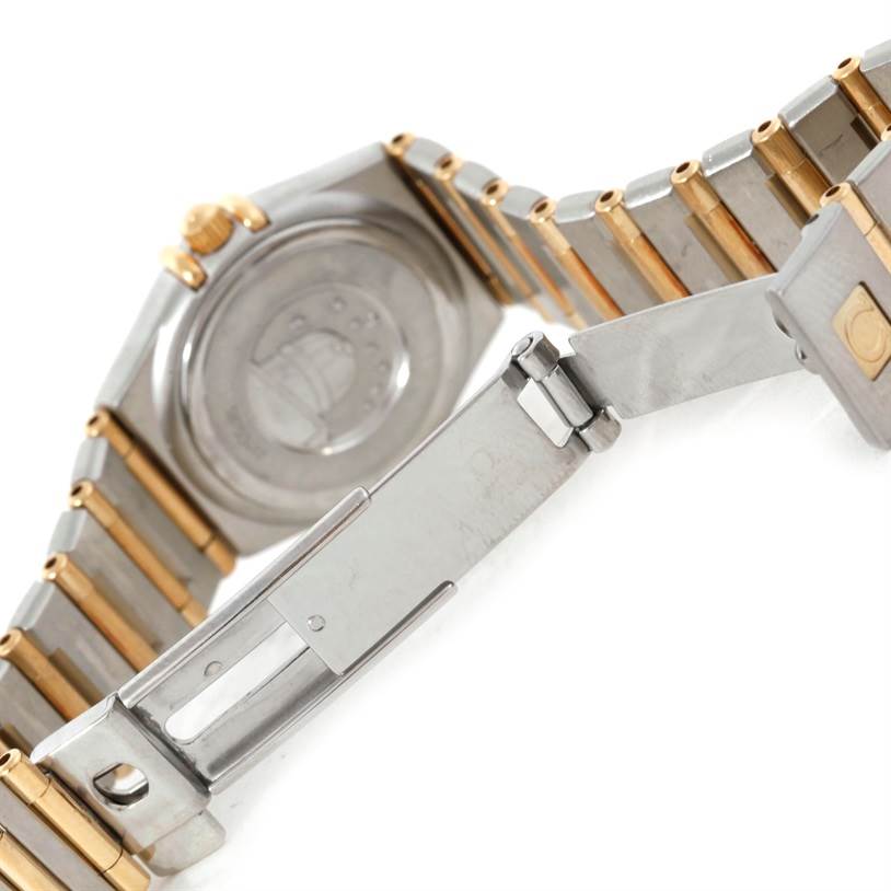 The image shows the back case and partially open bracelet clasp of the Omega 1372.70.00 Women
s Steel and Gold (two tone) Mother of Pearl Dial 1372.70.00 Women
s Steel and Gold (two tone) Mother of Pearl Dial Constellation Steel and Gold Ladies Watch 1372.70.00.