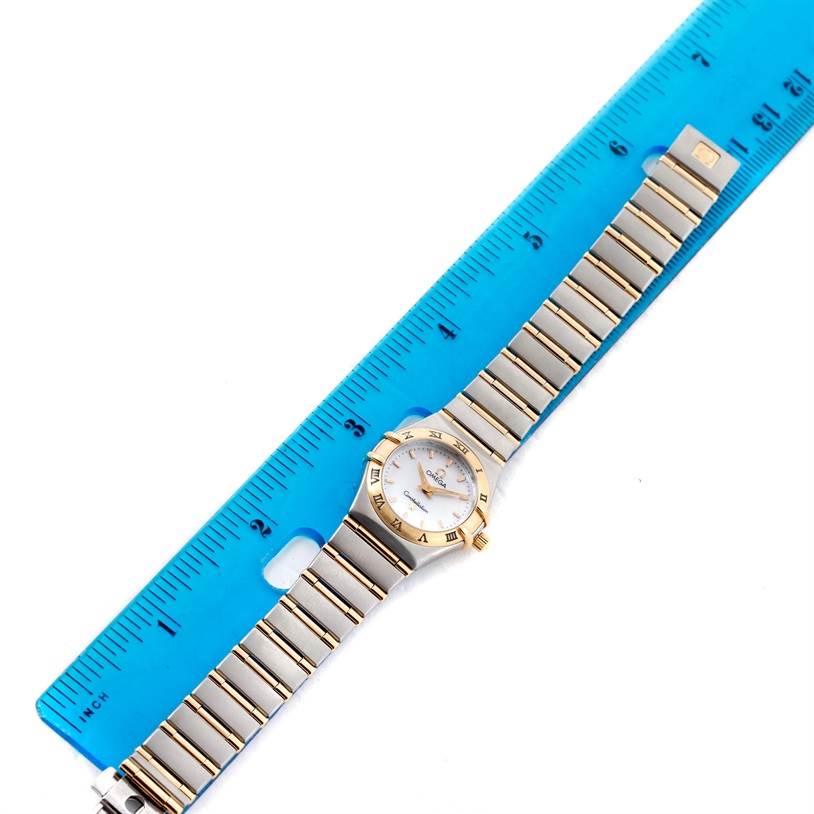 The Omega 1372.70.00 Women
s Steel and Gold (two tone) Mother of Pearl Dial 1372.70.00 Women
s Steel and Gold (two tone) Mother of Pearl Dial Constellation Steel and Gold Ladies Watch 1372.70.00 is shown from a top-down angle, displaying the entire watch alongside a ruler.