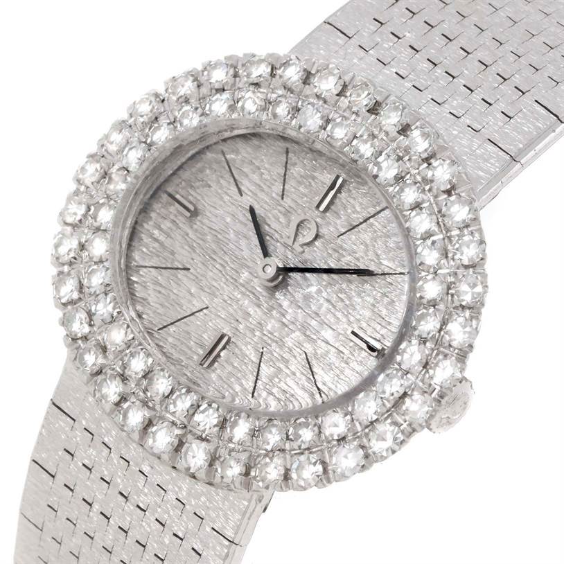 This image features an angled view of the Omega Women
s White Gold Silver Dial Women
s White Gold Silver Dial Vintage Ladies 18k White Gold 2 ct Diamond Cocktail Watch displaying the face, bezel, and part of the band.