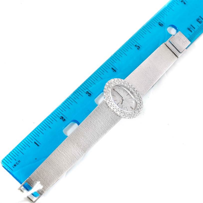 The Vintage Ladies 18k White Gold 2 ct Diamond Cocktail Watch by Omega Women
s White Gold Silver Dial Women
s White Gold Silver Dial is shown laid flat next to a blue ruler.