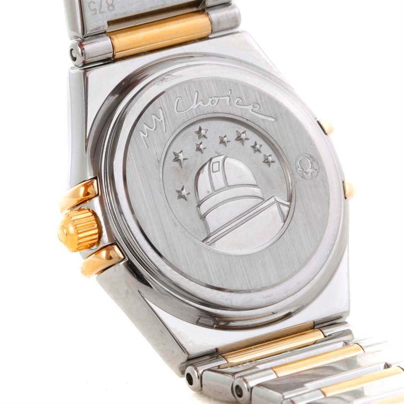 This image shows the back case and part of the bracelet of the Omega 1365.71.00 Women
s Steel and Gold (two tone) Mother of Pearl Dial 1365.71.00 Women
s Steel and Gold (two tone) Mother of Pearl Dial Constellation Mini Steel Yellow Gold Diamond Watch model 1365.71.00.
