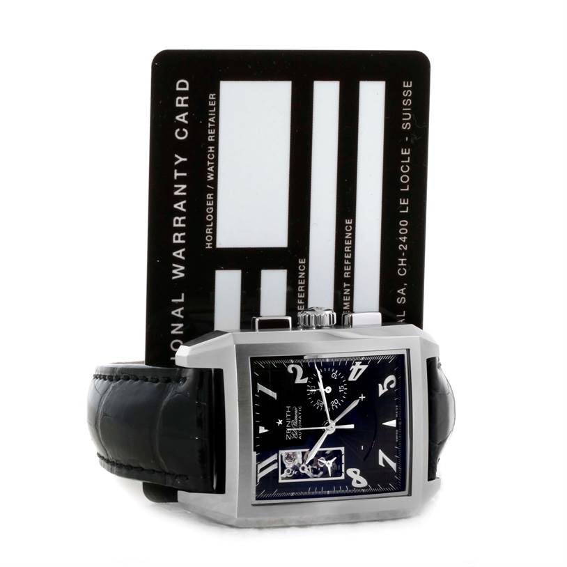 The image shows a Zenith Port Royal 03.0550.4021/21.C503 Men's Stainless Steel Black Dial 03.0550.4021/21.C503 Men's Stainless Steel Black Dial watch laid flat with a visible black face, silver case, black strap, and warranty card in the background.