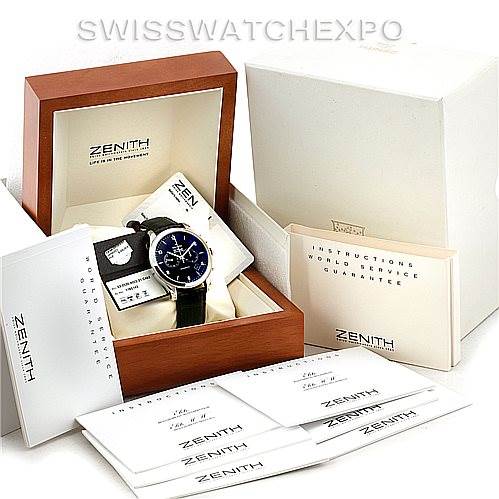 The image shows a Zenith El Primero 03.0520.4002 Men
s Stainless Steel Black Dial 03.0520.4002 Men
s Stainless Steel Black Dial watch in its box, surrounded by various instruction manuals and warranty cards.