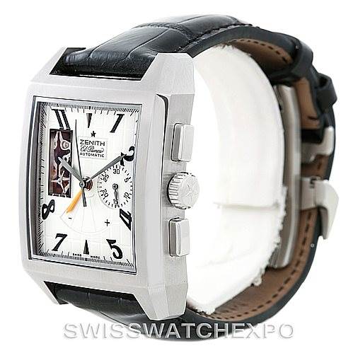 The image shows a Zenith Port Royal 03.0550.4021/01.C503 Men's Stainless Steel Silver Dial 03.0550.4021/01.C503 Men's Stainless Steel Silver Dial watch from a side angle, highlighting its rectangular face, crown, and pushers, as well as its leather strap.