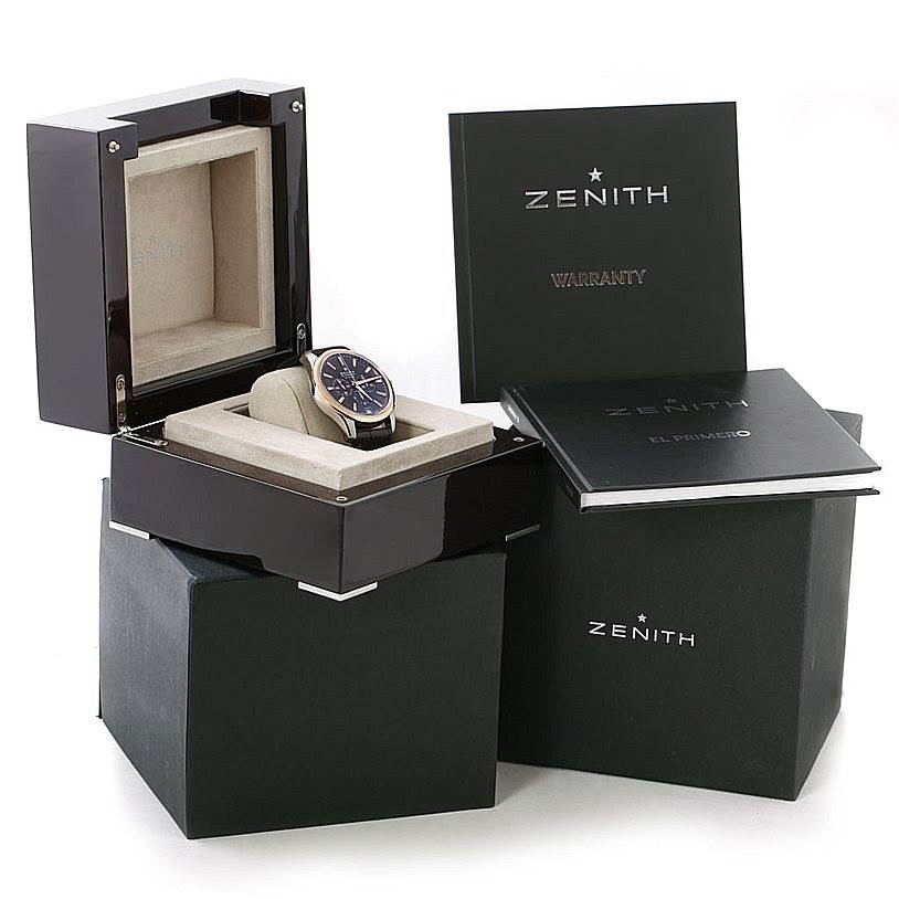 The Zenith Captain 51.2112.400 Men's Steel and Gold (two tone) Brown Dial 51.2112.400 Men's Steel and Gold (two tone) Brown Dial model watch is displayed in an open box, along with warranty and instruction booklets nearby.