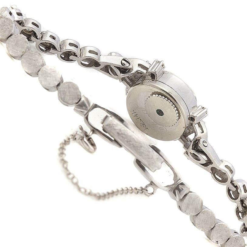 The image shows the back and side view of the Longines Women's White Gold Silver Dial Women's White Gold Silver Dial Vintage Ladies 14k White Gold Diamonds Watch, highlighting its clasp and chain details.