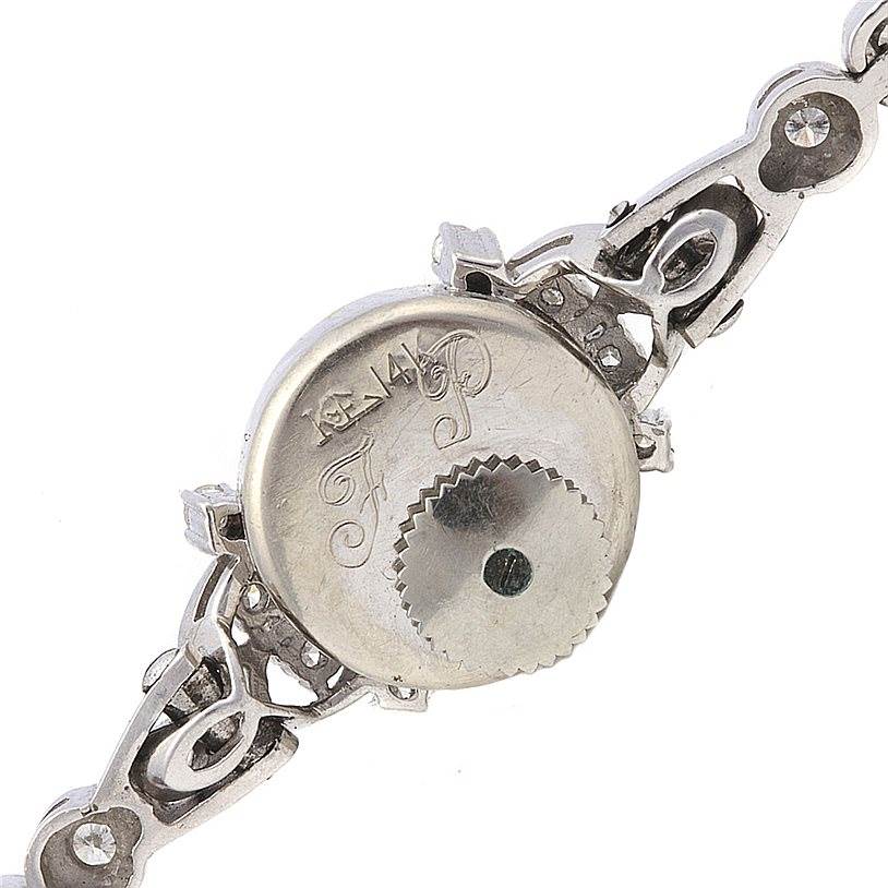 This image shows the back of a Longines Women's White Gold Silver Dial Women's White Gold Silver Dial Vintage Ladies 14k White Gold Diamonds Watch with intricate bracelet details.