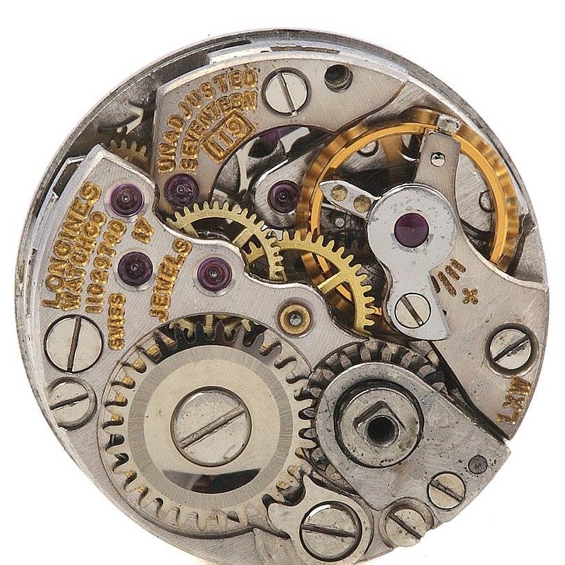This is a close-up view of the inner mechanics of the Longines Women's White Gold Silver Dial Women's White Gold Silver Dial Vintage Ladies 14k w Gold Diamonds Watch model.