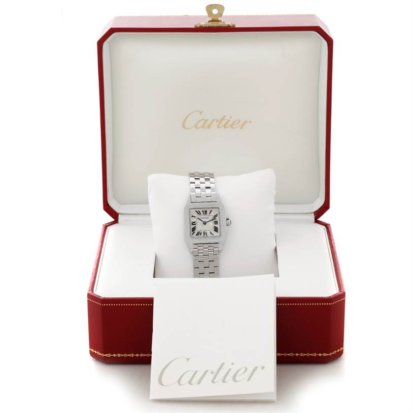 The Cartier Santos Demoiselle W25065Z5 Women
s Stainless Steel Silver Dial W25065Z5 Women
s Stainless Steel Silver Dial watch is shown from the front, displayed inside an open red and white box.