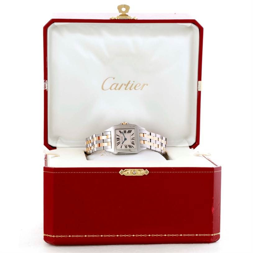 The Cartier Santos Demoiselle W25067Z6 Women's Steel and Gold (two tone) Silver Dial W25067Z6 Women's Steel and Gold (two tone) Silver Dial watch is shown front-facing in an open red Cartier box.