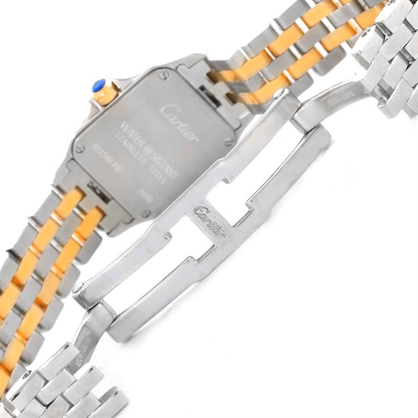 The image shows the backside and open clasp of a Santos Demoiselle model by Cartier, highlighting the bracelet and case back.