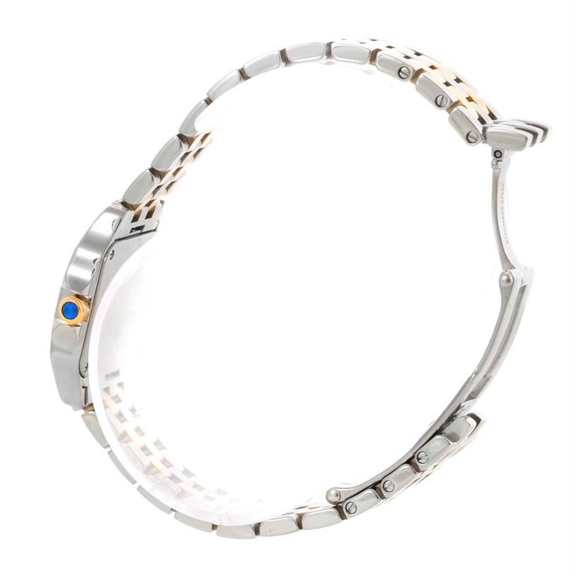 The image shows a side view of the Cartier Santos Demoiselle W25066Z6 Women's Steel and Gold (two tone) Silver Dial W25066Z6 Women's Steel and Gold (two tone) Silver Dial watch, highlighting the bracelet and crown with a blue cabochon.
