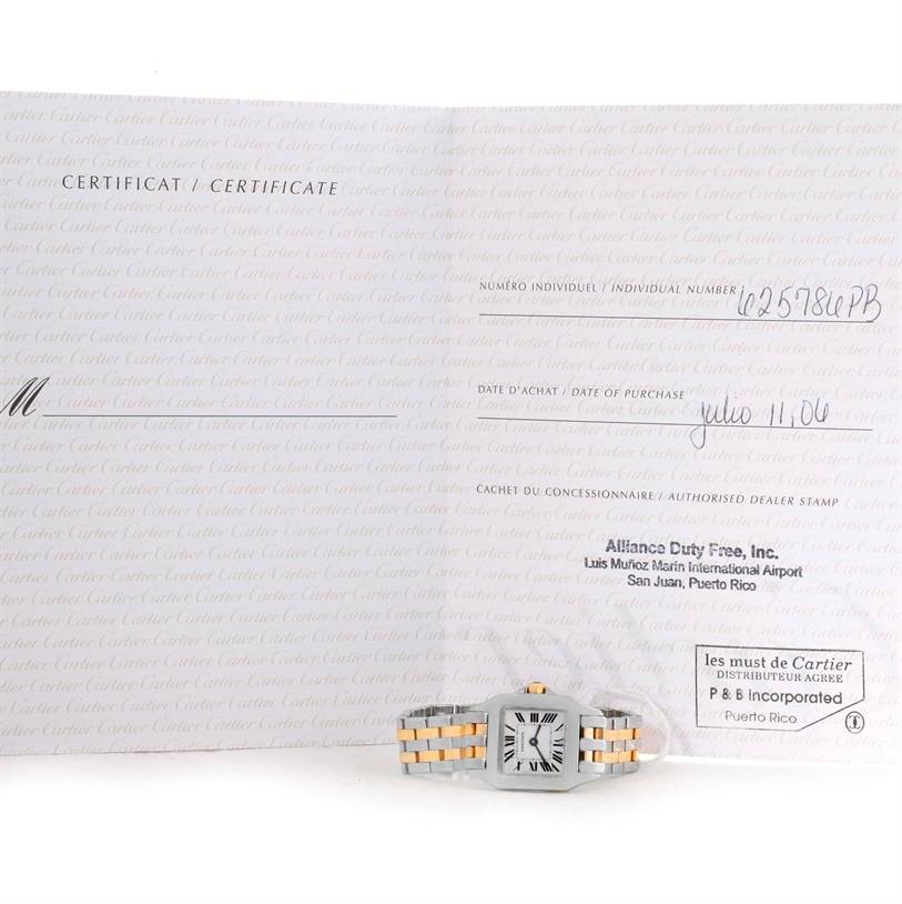 This image shows a Cartier Santos Demoiselle W25066Z6 Women's Steel and Gold (two tone) Silver Dial W25066Z6 Women's Steel and Gold (two tone) Silver Dial watch placed below its certificate of authenticity.