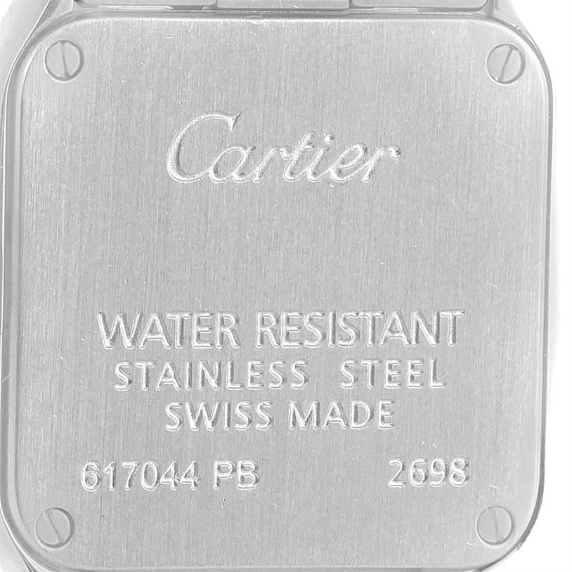 The image shows the back of a Santos Demoiselle watch by Cartier, highlighting its inscriptions and material details.