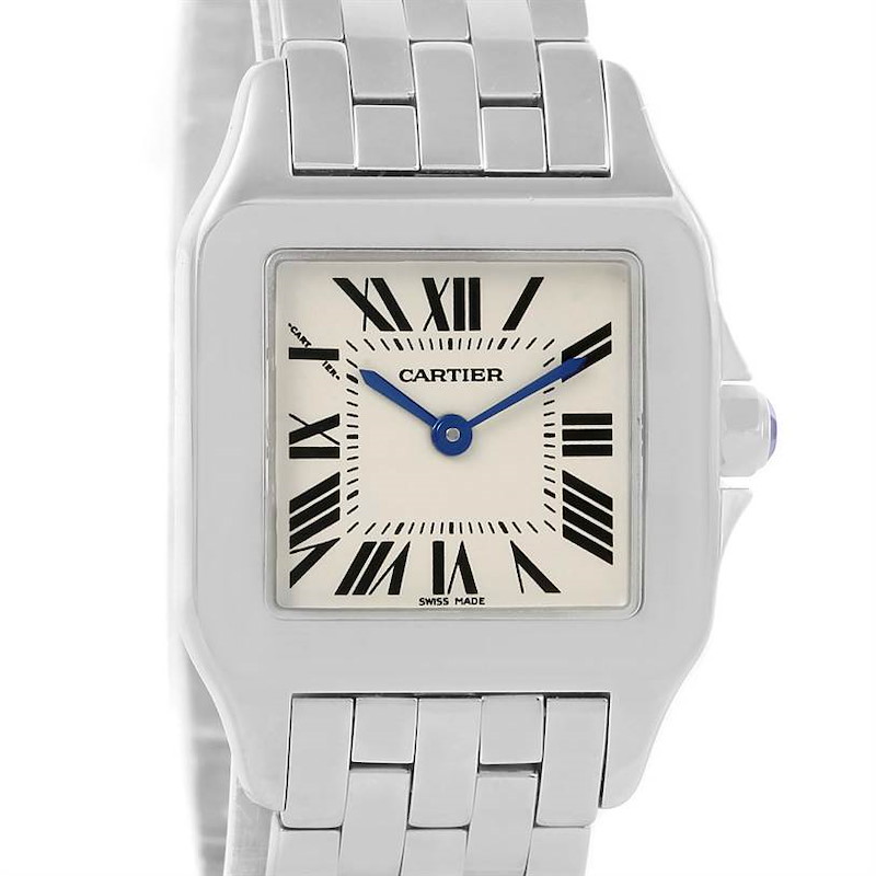 The image shows a front view of a Cartier Santos Demoiselle watch, highlighting the face, numerals, and part of the strap.