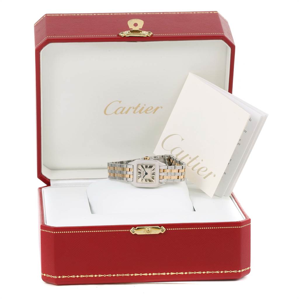 The Cartier Santos Demoiselle W25066Z6 Women's Steel and Gold (two tone) Silver Dial W25066Z6 Women's Steel and Gold (two tone) Silver Dial watch is shown in its box along with accompanying documents.