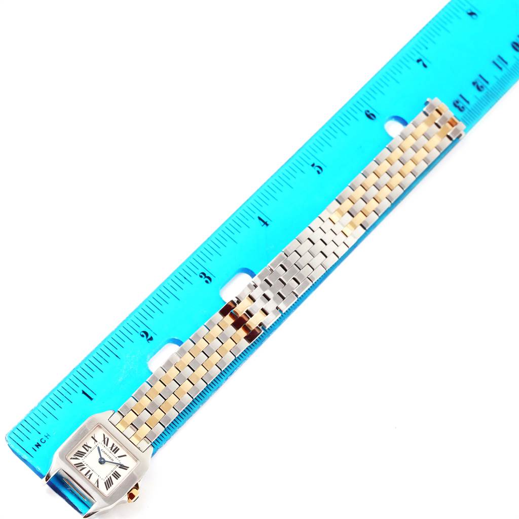 The Santos Demoiselle model by Cartier is shown from a top view, featuring its face and bracelet alongside a ruler for measurement.