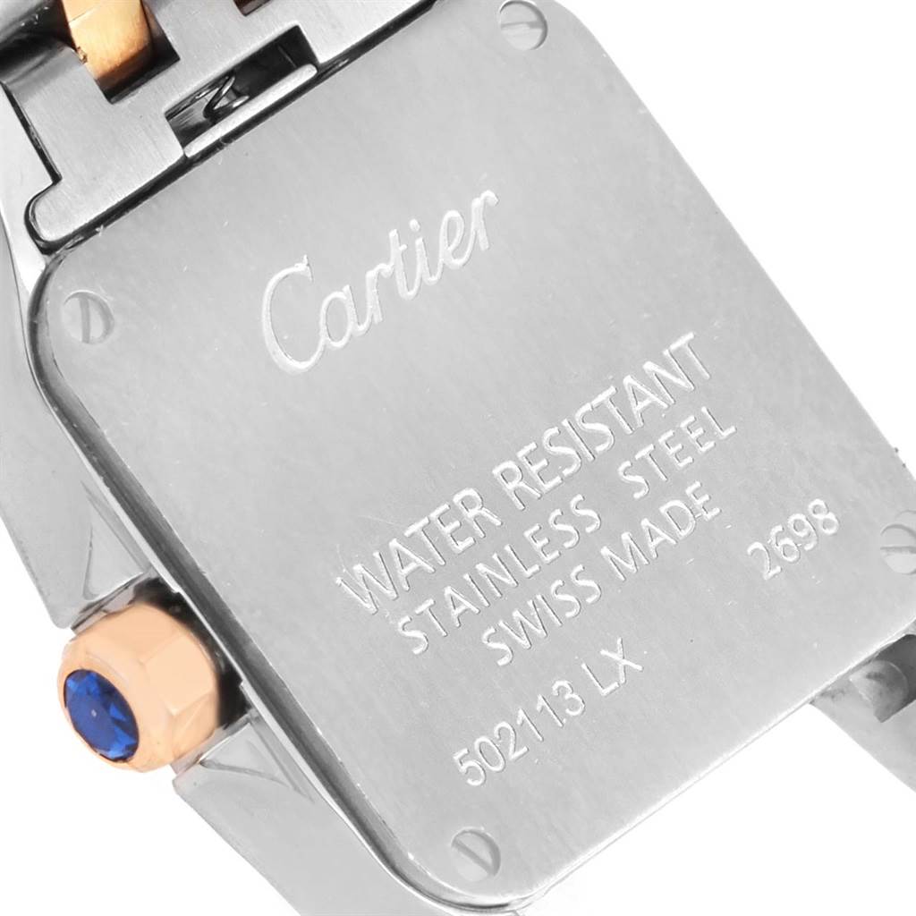 This image shows the case back of the Cartier Santos Demoiselle W25074Y9 Women's Steel and Gold (two tone) Mother of Pearl Dial W25074Y9 Women's Steel and Gold (two tone) Mother of Pearl Dial watch, highlighting brand engraving, water resistance details, and crown.