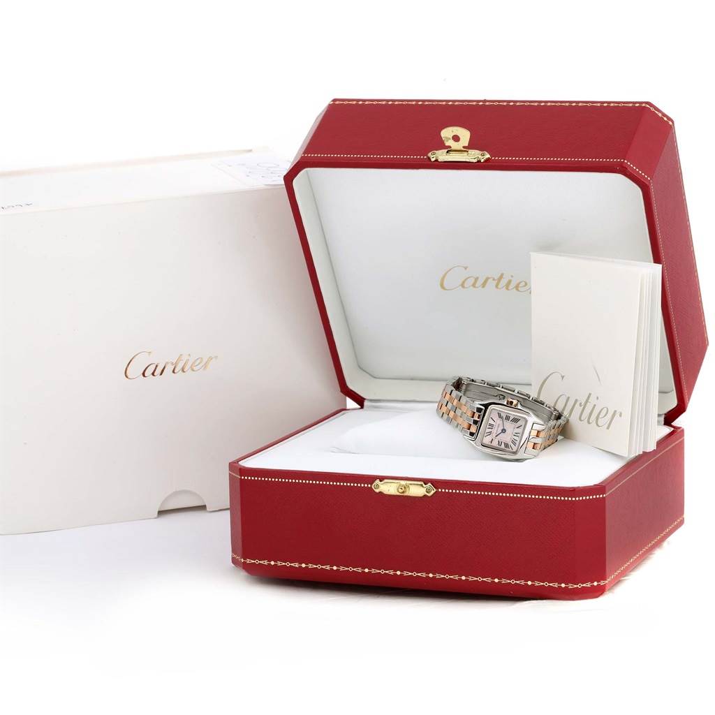 The image shows the Cartier Santos Demoiselle W25074Y9 Women's Steel and Gold (two tone) Mother of Pearl Dial W25074Y9 Women's Steel and Gold (two tone) Mother of Pearl Dial watch inside its open red and white box, alongside a manual or booklet.