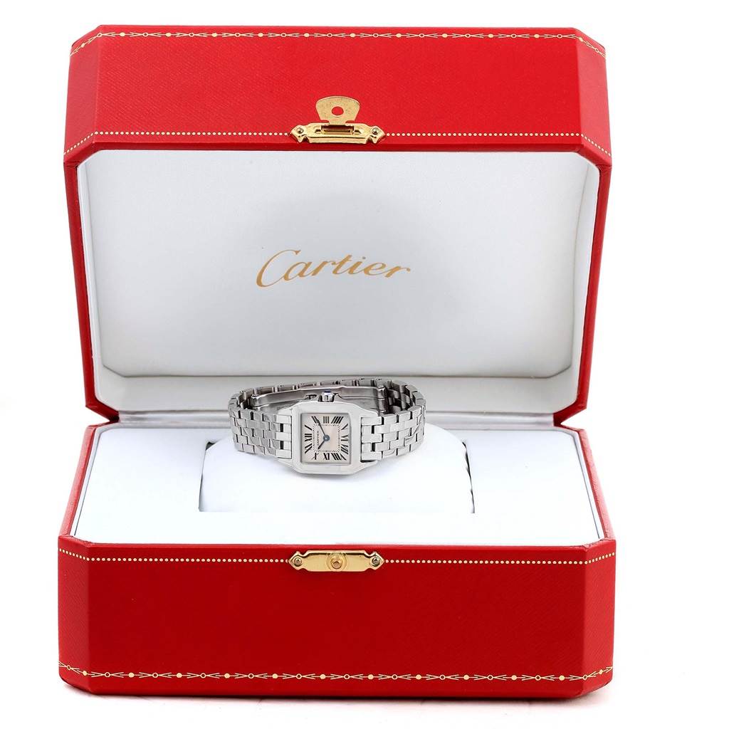 The Cartier Santos Demoiselle W25064Z5 Women's Stainless Steel Silver Dial W25064Z5 Women's Stainless Steel Silver Dial watch is shown inside an open red Cartier box, showcasing its face and metal bracelet.