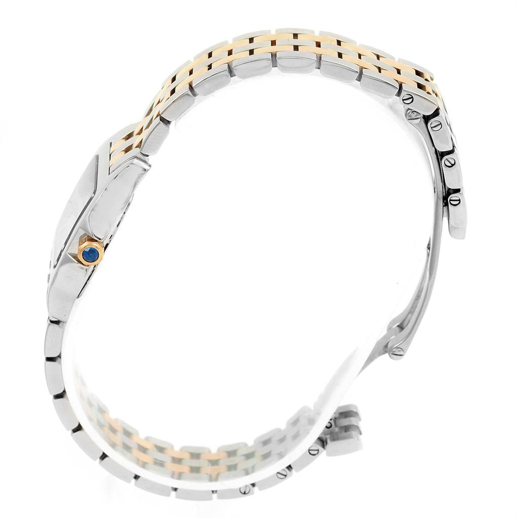 The image shows a side angle of the Cartier Santos Demoiselle W25066Z6 Women's Steel and Gold (two tone) Silver Dial W25066Z6 Women's Steel and Gold (two tone) Silver Dial watch, highlighting the bezel, crown, and two-tone bracelet.