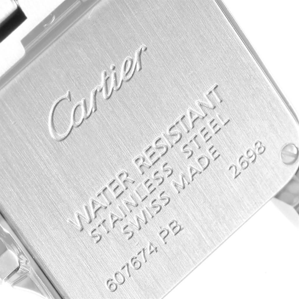 The image shows the back case of the Cartier Santos Demoiselle W25064Z5 Women
s Stainless Steel Silver Dial W25064Z5 Women
s Stainless Steel Silver Dial watch at a close-up angle, displaying engraved details.