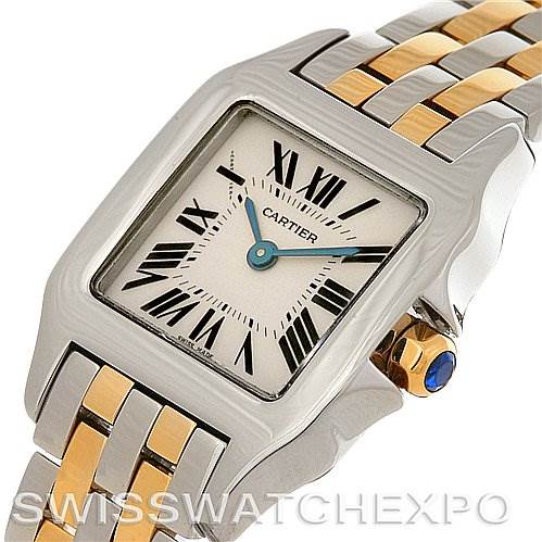 The image shows a close-up angle of a Cartier Santos Demoiselle W25066Z6 Women's Steel and Gold (two tone) Silver Dial W25066Z6 Women's Steel and Gold (two tone) Silver Dial watch, highlighting its dial, Roman numerals, and two-tone bracelet.