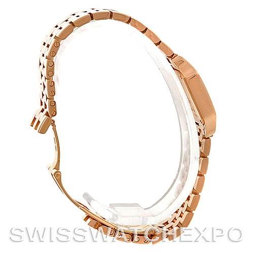 The image shows a Cartier Santos Demoiselle W25077X9 Women
s Rose Gold Silver Dial W25077X9 Women
s Rose Gold Silver Dial watch from a side angle, highlighting its bracelet and case.