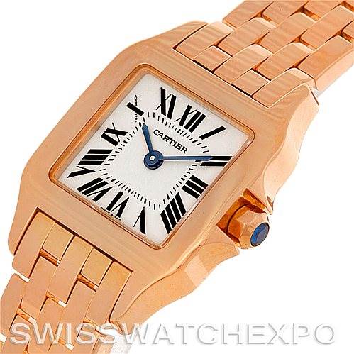 The image shows a close-up angled view of the Santos Demoiselle watch by Cartier, highlighting the face, bezel, and part of the bracelet.