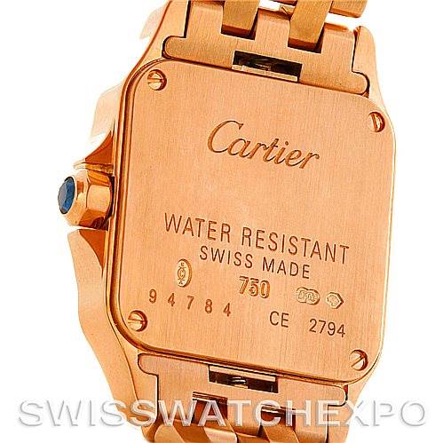 This image shows the case back of the Cartier Santos Demoiselle W25077X9 Women
s Rose Gold Silver Dial W25077X9 Women
s Rose Gold Silver Dial watch, featuring engravings and part of the bracelet.