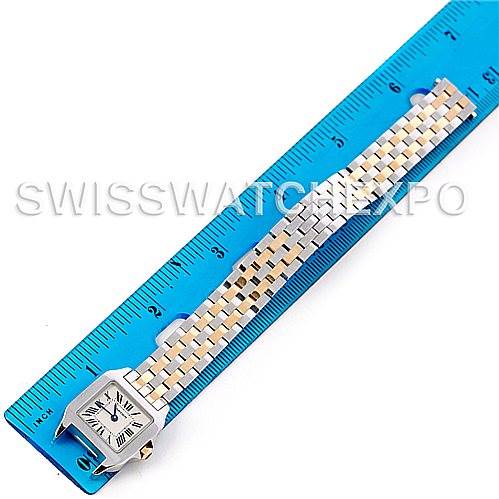 The image shows the Cartier Santos Demoiselle W25066Z6 Women's Steel and Gold (two tone) Silver Dial W25066Z6 Women's Steel and Gold (two tone) Silver Dial watch lying flat with a blue ruler for size reference.