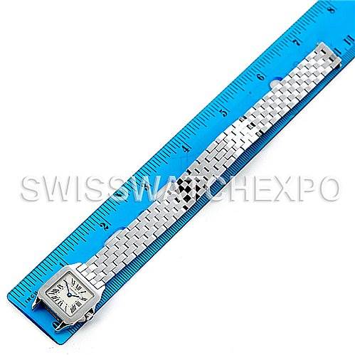 The image shows the watch and bracelet of the Cartier Santos Demoiselle W25064Z5 Women
s Stainless Steel Silver Dial W25064Z5 Women
s Stainless Steel Silver Dial model laid flat against a ruler.