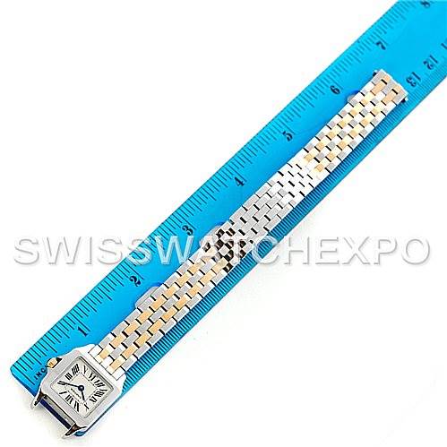 The Cartier Santos Demoiselle W25066Z6 Women's Steel and Gold (two tone) Silver Dial W25066Z6 Women's Steel and Gold (two tone) Silver Dial watch is shown from an overhead angle with a blue ruler for scale, highlighting its face and full bracelet.