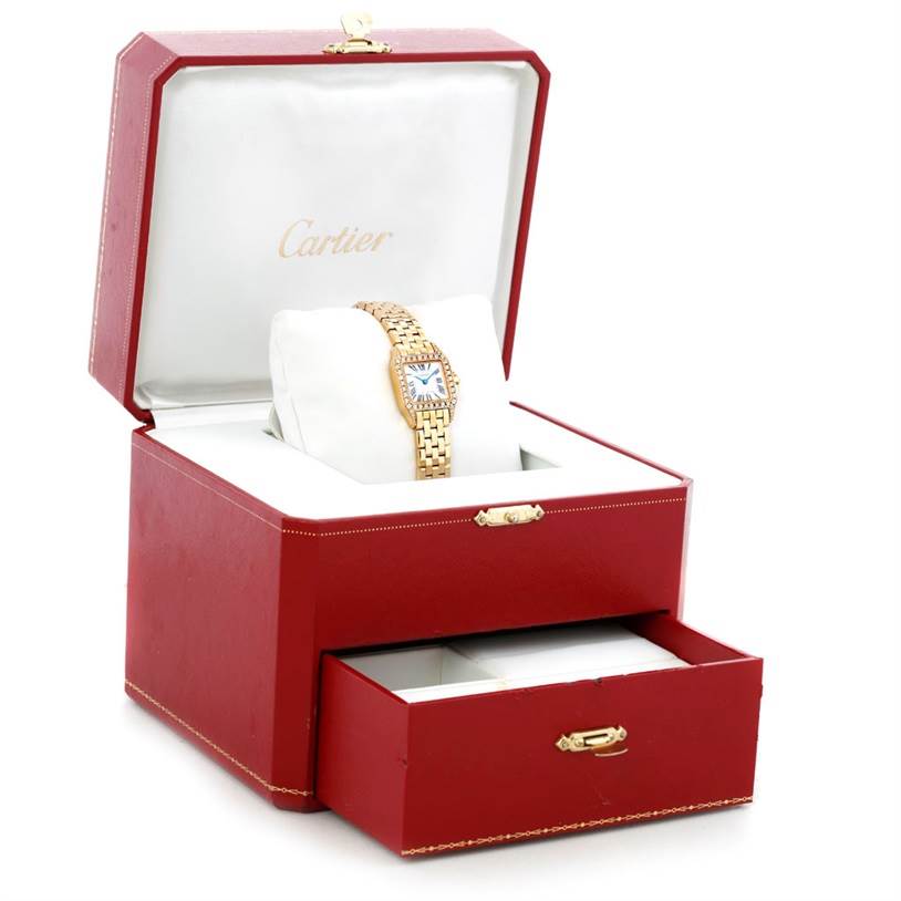The image shows a Cartier Santos Demoiselle WF9001Y7 Women's Yellow Gold Silver Dial WF9001Y7 Women's Yellow Gold Silver Dial watch in a red Cartier box with a partially open drawer.