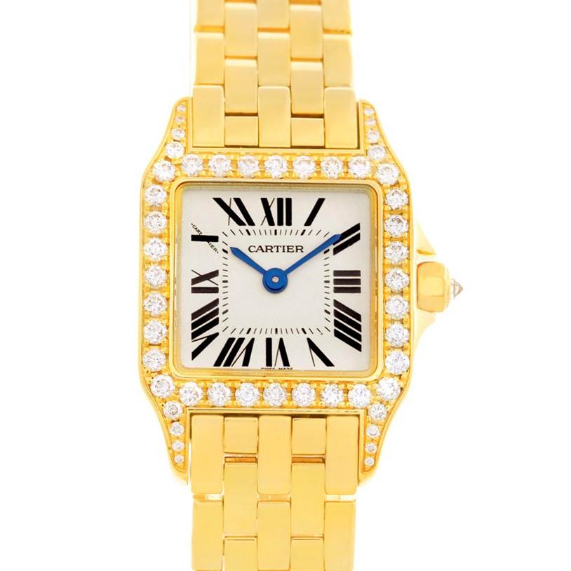 The image shows a frontal view of the Cartier Santos Demoiselle WF9001Y7 Women's Yellow Gold Silver Dial WF9001Y7 Women's Yellow Gold Silver Dial watch, highlighting its gold bracelet, diamond bezel, and Roman numeral dial.