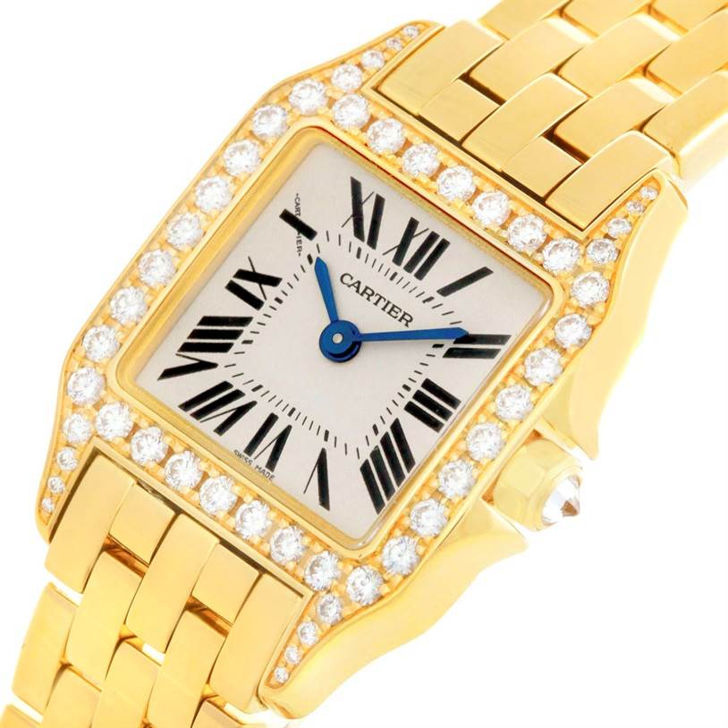 The image shows an angled view of the Cartier Santos Demoiselle WF9001Y7 Women's Yellow Gold Silver Dial WF9001Y7 Women's Yellow Gold Silver Dial watch, highlighting its diamond-studded bezel and gold bracelet.