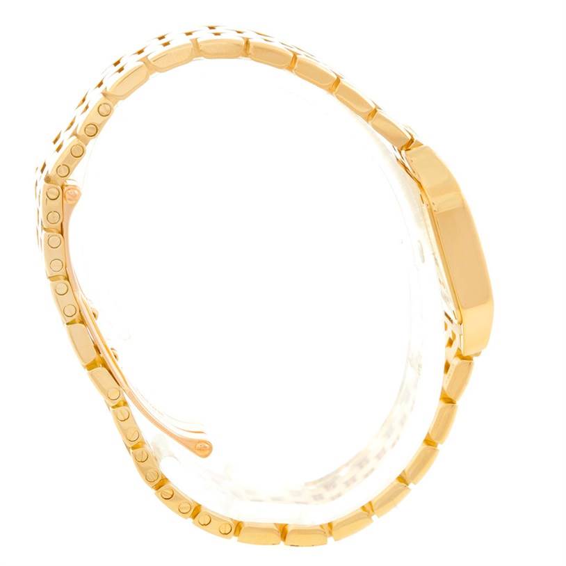 The Cartier Santos Demoiselle WF9001Y7 Women's Yellow Gold Silver Dial WF9001Y7 Women's Yellow Gold Silver Dial watch is shown from a side profile, highlighting its gold bracelet and case.