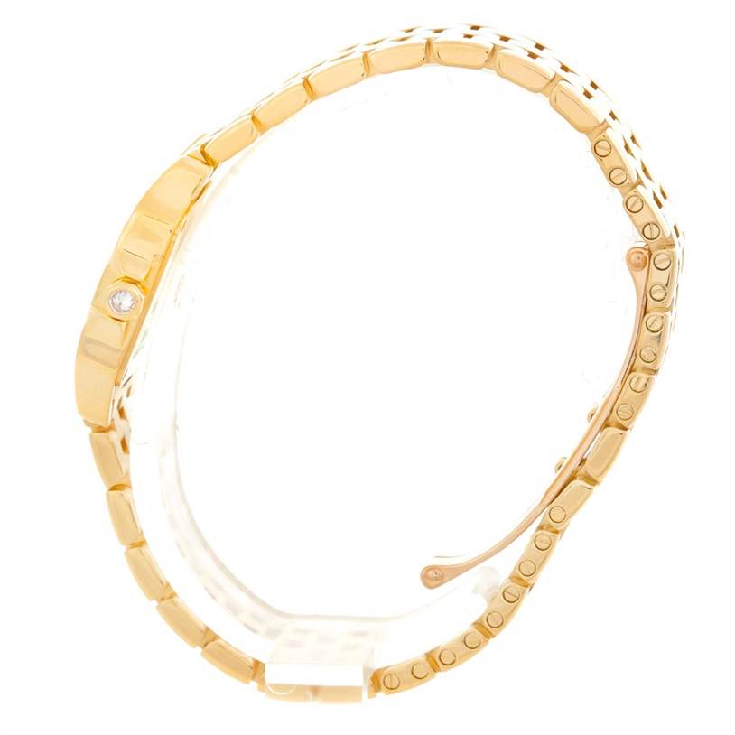 This side view of the Cartier Santos Demoiselle WF9001Y7 Women's Yellow Gold Silver Dial WF9001Y7 Women's Yellow Gold Silver Dial watch shows the gold bracelet and clasp mechanism.