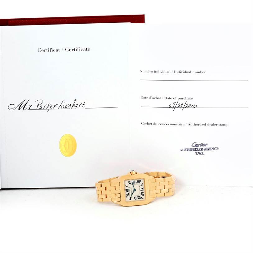The image shows a Cartier Santos Demoiselle W25062X9 Women's Yellow Gold Silver Dial W25062X9 Women's Yellow Gold Silver Dial watch with its certificate, both viewed from the front.